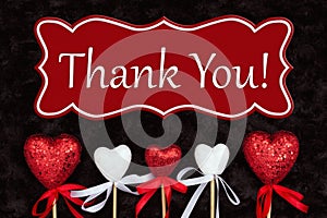 Thank You message with white and red hearts on black