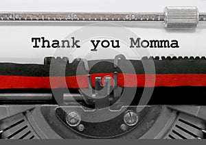 Thank you Momma phrase by the old typewriter on white paper