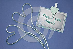 Thank you NHS two hearts banner. Two hearts on purple background with letters. photo
