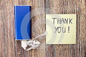 Thank You note, and blue colored energy bank and USB cable is attached. In the above picture gratitude, appreciation, or acknowled