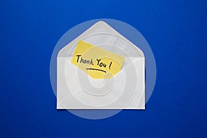 Thank you note on yellow paper in an envelope