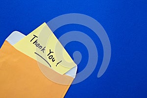 Thank you note on yellow paper in an envelope