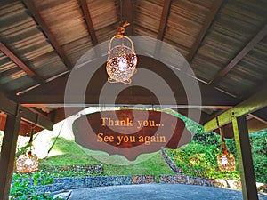 Thank you and see you again signage on wooden hanging top.