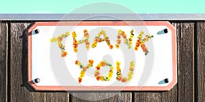 THANK YOU sign of yellow orange flowers collage, enamel, metal or pottery sign, wooden wall. coral frame, turquoise sky