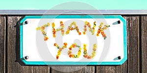 THANK YOU sign of yellow orange flowers collage, enamel, metal or pottery sign, wooden wall. frame, turquoise sky