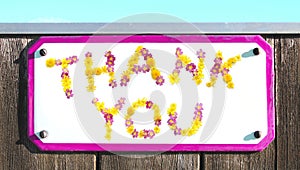 THANK YOU sign of yellow pink red and orange flowers collage, enamel, metal or pottery sign, wooden wall. frame, turquoise sky