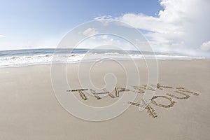 Thank you written on a beach
