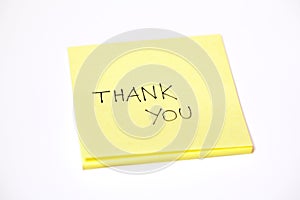 Thank you written on a post-it or a sticky note, isolated on white