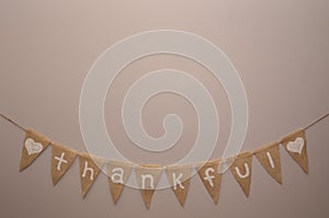 Thankful burlap sign on light beige background