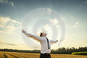 Thankful Businessman with Open Arms at the Field