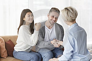 Thankful Couple And Family Counselor Shaking Hands Sitting In Office