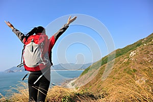 Thankful hiking woman seaside mountain