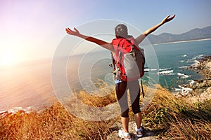 Thankful hiking woman seaside mountain