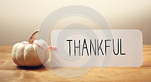 Thankful message with a small pumpkin