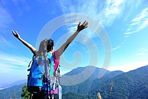 Thankful mountain climbing woman