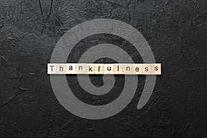 Thankfulness word written on wood block. Thankfulness text on cement table for your desing, concept photo
