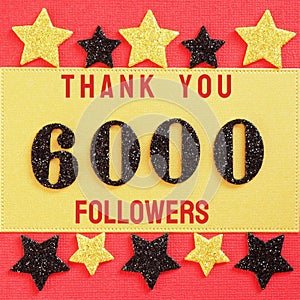 Thanks 6000, 6K followers. message with black shiny numbers on red and gold background with black and golden shiny stars