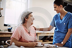 Thanks for always being by my side. an attractive young female caregiver with a senior patient in a nursing home.