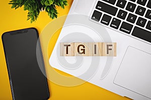 Thanks God It`s Friday! TGIF Text on Word Block on Laptop over Work Desk photo