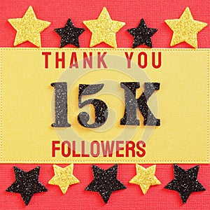 Thanks 15K, 15000 followers. message with black shiny numbers on red and gold background with black and golden shiny stars