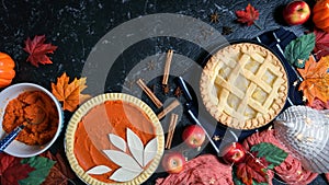 Thanksgiving apple and pumpkin pies on dark marble table stop motion animation.