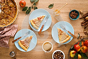 Thanksgiving autumn apple pie with fresh fruits and walnuts on wooden table
