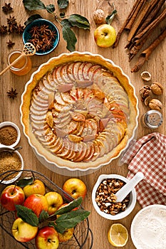 Thanksgiving autumn apple pie with fresh fruits and walnuts on wooden table