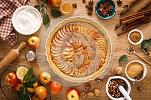 Thanksgiving autumn apple pie with fresh fruits and walnuts on wooden table