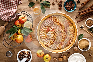 Thanksgiving autumn apple pie with fresh fruits and walnuts on wooden table