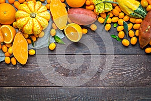 Thanksgiving Autumn Background, Variety of Orange Fruits and Vegetables on Dark Wooden Background with Free Space for Text