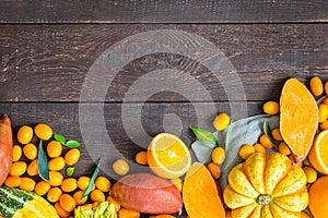 Thanksgiving Autumn Background, Variety of Orange Fruits and Vegetables on Dark Wooden Background with Free Space for Text