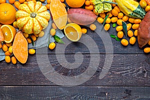 Thanksgiving Autumn Background, Variety of Orange Fruits and Vegetables on Dark Wooden Background with Free Space for Text