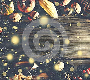 Thanksgiving background with falling gold snow. Pumpkins and various autumn fruits. Frame with seasonal ingredients in Thanksgivin