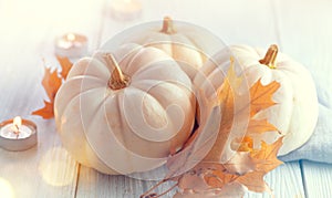 Thanksgiving background. Holiday scene. Wooden table, decorated with pumpkins, autumn leaves