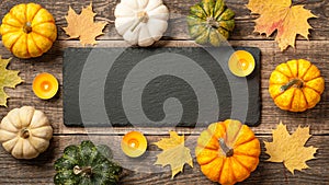 Thanksgiving background with pumpkins, autumn leaves and candles