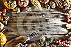 Thanksgiving background. Pumpkins and various autumn fruits. Frame with seasonal ingredients in Thanksgiving Day. Food frame