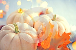 Thanksgiving background. Wooden table, decorated with pumpkins, autumn leaves and candles