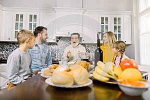 Thanksgiving Celebration Tradition Family Dinner Concept. Family with kids. Roasted turkey, fresh fruits, cookies and