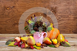 Thanksgiving centerpiece with wild flowers in pink pitcher vase