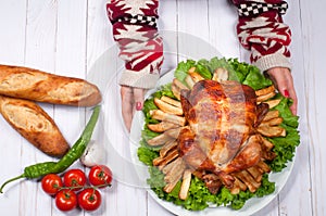 Homemade roasted whole turkey on wooden table for Thanksgiving.