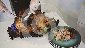 Thanksgiving or Christmas turkey dinner. Hands of a man carving a roast turkey