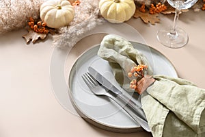 Thanksgiving day autumn table setting in natural colors decorated white pumpkins.