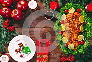 Thanksgiving day. Christmas table dinner time with roasted meats decorated in Christmas style. The concept of a family holiday