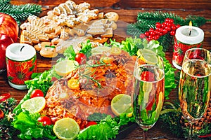 Thanksgiving day. Christmas table dinner time with roasted meats decorated in Christmas style. The concept of a family holiday