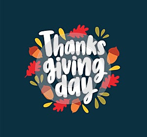 Thanksgiving Day lettering written with elegant cursive calligraphic font and decorated by fallen autumn leaves and