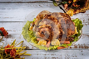 Thanksgiving Day roasted chicken Thanksgiving table served with decorated bright autumn leaves