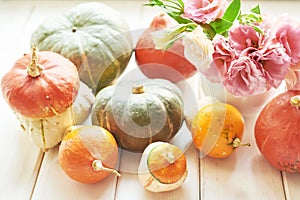 Thanksgiving Day table. Happy Halloween. Pumpkins, apples and flowers. Bright autumn background. Colorful autumn card. Autumn