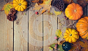 Thanksgiving dinner background. Autumn pumpkin and fall leaves on wooden table