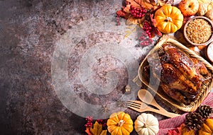 Thanksgiving dinner background concept with turkey roasted and all sides dishes, fall leaves, pumpkin and seasonal autumnal decor