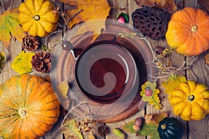 Thanksgiving dinner background with plate. Autumn pumpkin and fall leaves on wooden table.